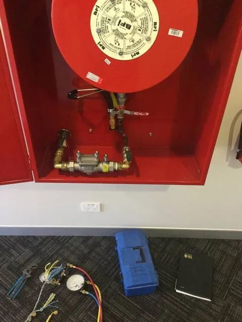 Red backflow prevention device - Reef City Plumbing in Beecher, QLD