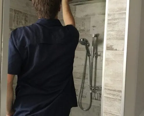 Plumber fitting shower screen in Gladstone