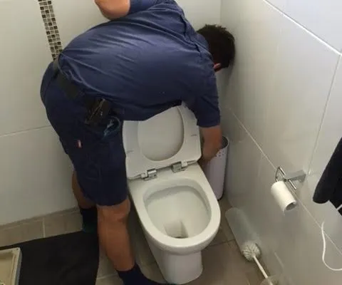 Plumber repairing toilet in Gladstone
