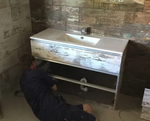 Plumber installing vanity basin in Gladstone