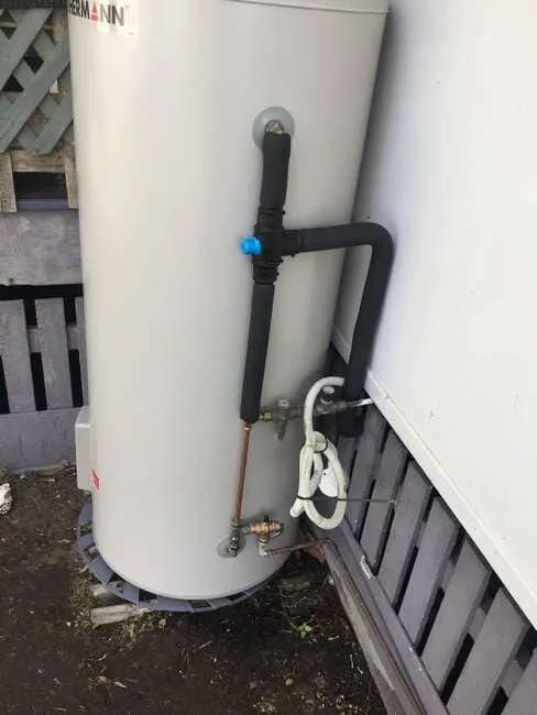 Hot water system installed on the side of a house