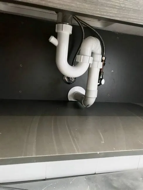 S-trap plumbing under bathroom bench
