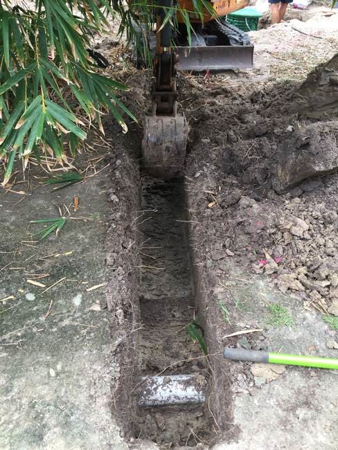 Plumbers in Gladstone digging septic tank hole