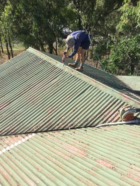 Michael on roof with safety harness